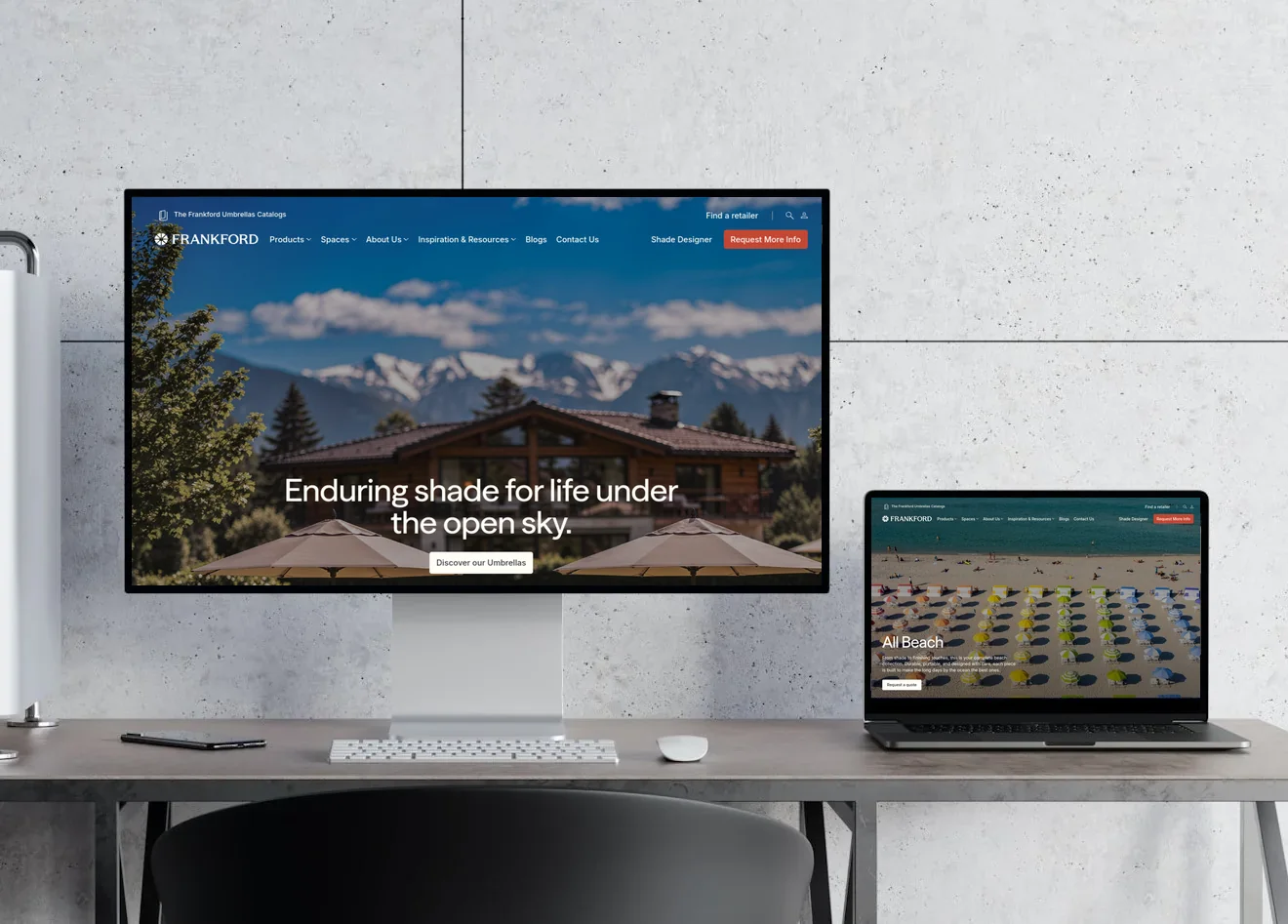 Frankford Umbrellas website shown on a desktop monitor and laptop on a desk