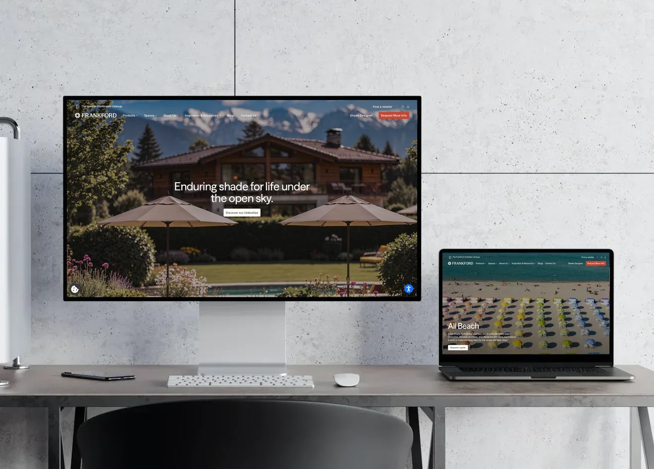 Frankford Umbrellas website shown on a desktop monitor and laptop on a desk